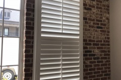 Shutter Mounted on Brick Wall
